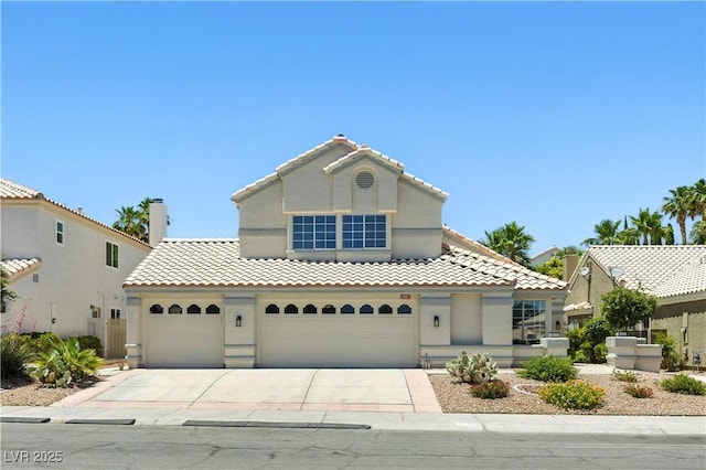 2105 Madagascar Ln, Las Vegas, NV 89117 - mediterranean / spanish-style house featuring concrete driveway, a tiled roof, stucco siding, and a garage