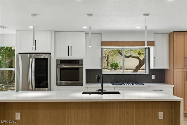 2105 Madagascar Ln, Las Vegas, NV 89117 - kitchen with stainless steel appliances, white cabinets, light countertops, and recessed lighting