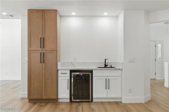 2105 Madagascar Ln, Las Vegas, NV 89117 - indoor wet bar with beverage cooler, light wood-style floors, and recessed lighting