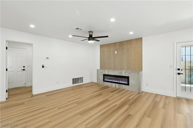 2105 Madagascar Ln, Las Vegas, NV 89117 - unfurnished living room with ceiling fan, light wood-style floors, a glass covered fireplace, and recessed lighting