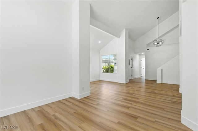 2105 Madagascar Ln, Las Vegas, NV 89117 - unfurnished living room featuring light wood finished floors and high vaulted ceiling