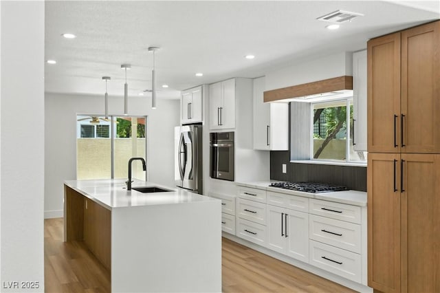 2105 Madagascar Ln, Las Vegas, NV 89117 - kitchen featuring appliances with stainless steel finishes, light wood-style floors, light countertops, and recessed lighting