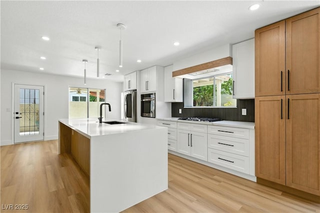 2105 Madagascar Ln, Las Vegas, NV 89117 - kitchen with stainless steel oven, refrigerator, light wood-type flooring, recessed lighting, and light countertops