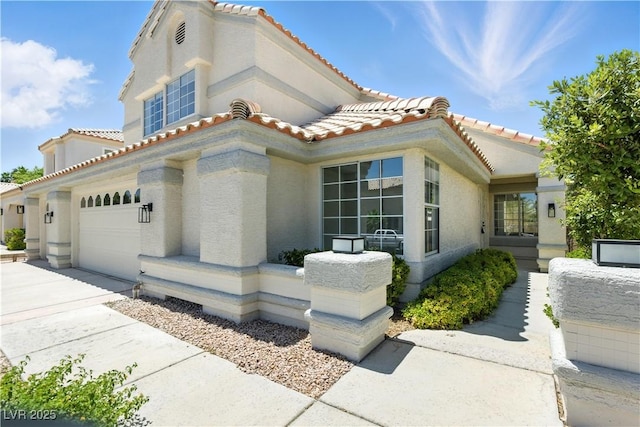 2105 Madagascar Ln, Las Vegas, NV 89117 - view of front of home with a tile roof, concrete driveway, stucco siding, and a garage