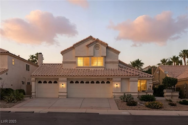 2105 Madagascar Ln, Las Vegas, NV 89117 - mediterranean / spanish-style house with driveway, a tiled roof, stucco siding, and an attached garage