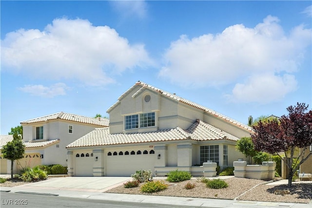 2105 Madagascar Ln, Las Vegas, NV 89117 - mediterranean / spanish-style home with driveway, stucco siding, a tile roof, and a garage
