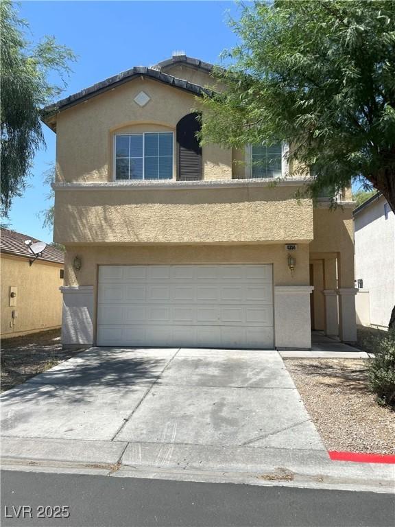 4356 Pittsfield St, Las Vegas, NV 89115 - view of front of property featuring stucco siding, a garage, and concrete driveway