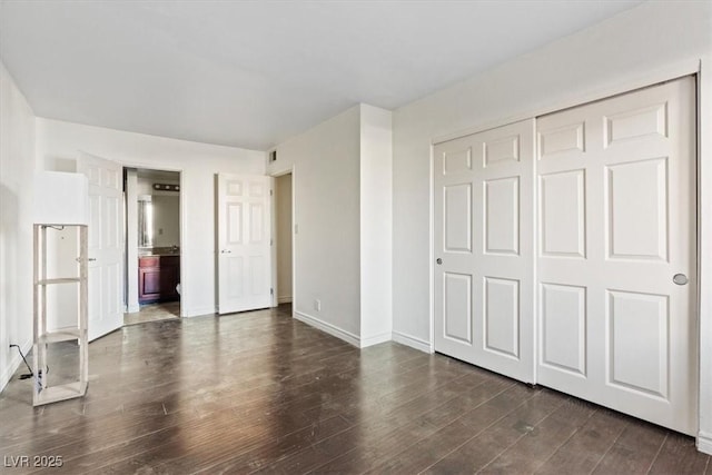 5200 Indian River Dr Unit 301, Las Vegas, NV 89103 - unfurnished bedroom with dark wood-style floors, a closet, and ensuite bathroom