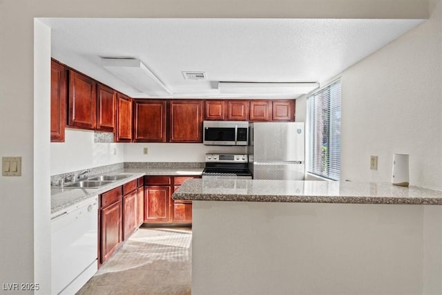 5200 Indian River Dr Unit 301, Las Vegas, NV 89103 - kitchen with stainless steel appliances, a peninsula, and light stone countertops