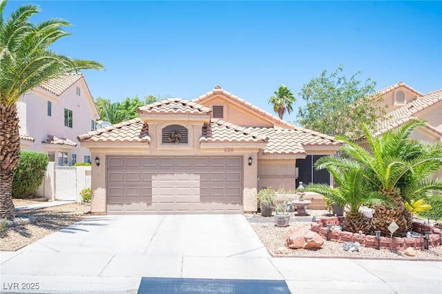 9632 Spanish Steps Ln, Las Vegas, NV 89117 - mediterranean / spanish-style home with a garage, concrete driveway, a tiled roof, and stucco siding