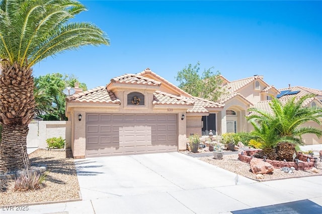 9632 Spanish Steps Ln, Las Vegas, NV 89117 - mediterranean / spanish home featuring an attached garage, stucco siding, driveway, and a tiled roof