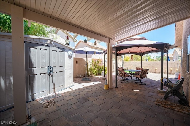 9632 Spanish Steps Ln, Las Vegas, NV 89117 - fenced backyard featuring a gazebo, a patio, a storage shed, and outdoor dining area