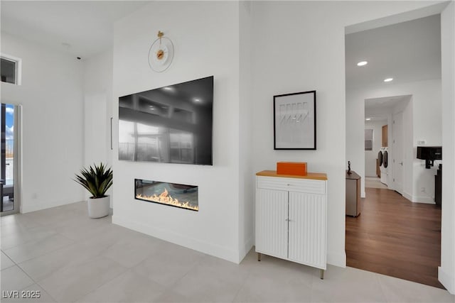 818 Calluna St, Las Vegas, NV 89138 - living room with washer and dryer, a glass covered fireplace, and recessed lighting