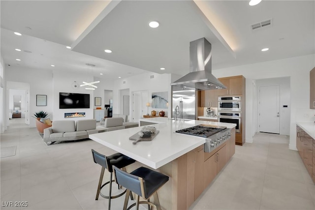 818 Calluna St, Las Vegas, NV 89138 - kitchen featuring modern cabinets, stainless steel appliances, range hood, light countertops, and a large island with sink