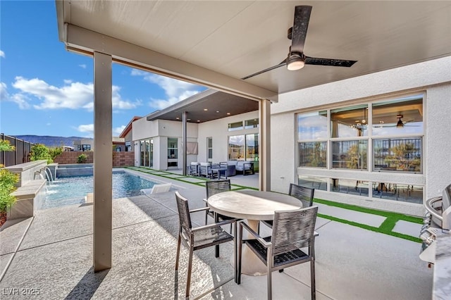 818 Calluna St, Las Vegas, NV 89138 - fenced backyard with a ceiling fan, a patio, and outdoor dining area