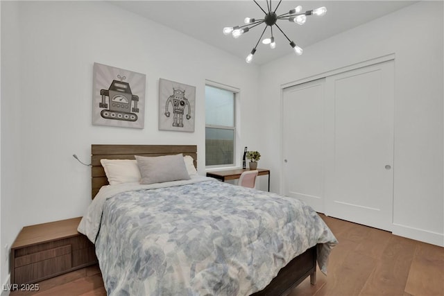 818 Calluna St, Las Vegas, NV 89138 - bedroom featuring wood finished floors, a chandelier, and a closet