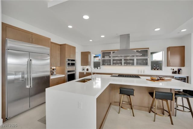 818 Calluna St, Las Vegas, NV 89138 - kitchen with appliances with stainless steel finishes, island range hood, glass insert cabinets, a large island with sink, and light countertops
