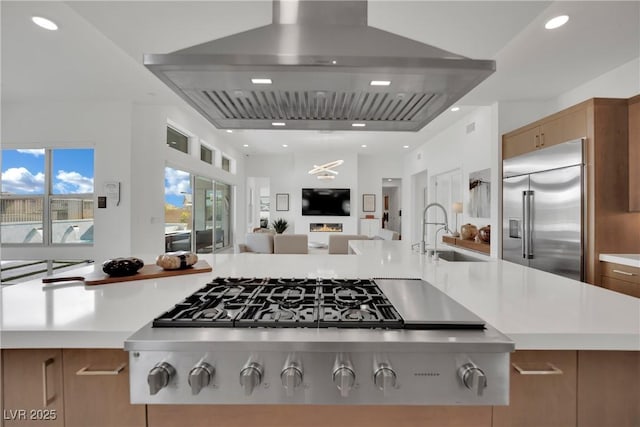 818 Calluna St, Las Vegas, NV 89138 - kitchen with stainless steel appliances, wall chimney range hood, open floor plan, light countertops, and recessed lighting