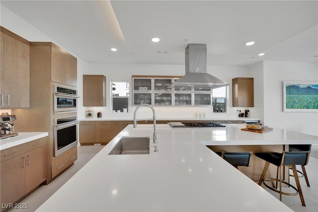 818 Calluna St, Las Vegas, NV 89138 - kitchen featuring island range hood, a breakfast bar, light countertops, recessed lighting, and cooktop