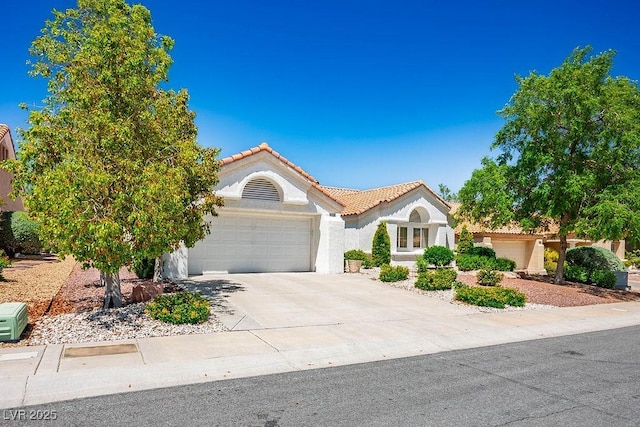 9704 Brawley Dr, Las Vegas, NV 89134 - mediterranean / spanish home with a garage, stucco siding, driveway, and a tiled roof