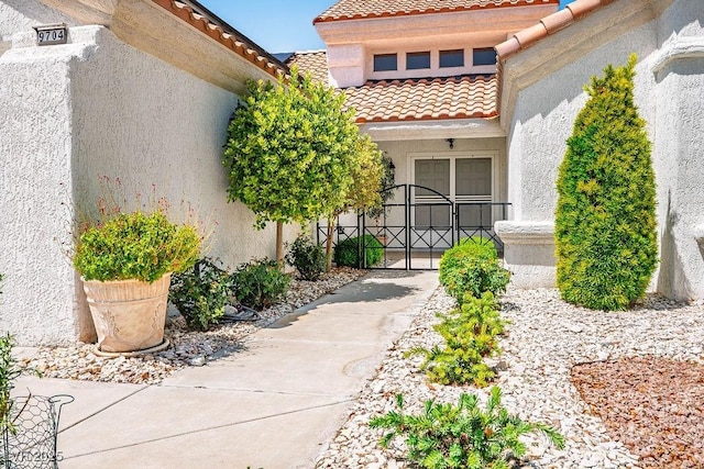 9704 Brawley Dr, Las Vegas, NV 89134 - entrance to property featuring a tiled roof, stucco siding, and a gate