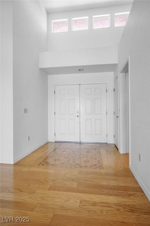 9704 Brawley Dr, Las Vegas, NV 89134 - entrance foyer with a high ceiling and light wood-style flooring