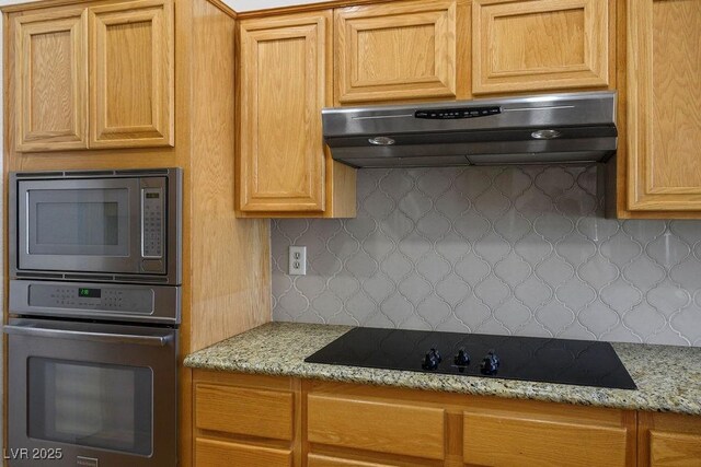 9704 Brawley Dr, Las Vegas, NV 89134 - kitchen with stainless steel appliances, ventilation hood, tasteful backsplash, and light stone countertops