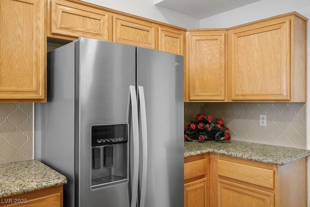 9704 Brawley Dr, Las Vegas, NV 89134 - kitchen featuring stainless steel fridge with ice dispenser, light stone counters, tasteful backsplash, and wallpapered walls