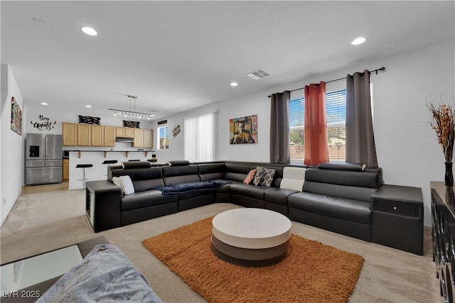 10045 Natchez Trace St, Las Vegas, NV 89178 - living room with light colored carpet, recessed lighting, and a chandelier