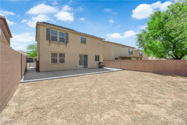 10045 Natchez Trace St, Las Vegas, NV 89178 - rear view of property with a fenced backyard, a patio, stucco siding, and a gate