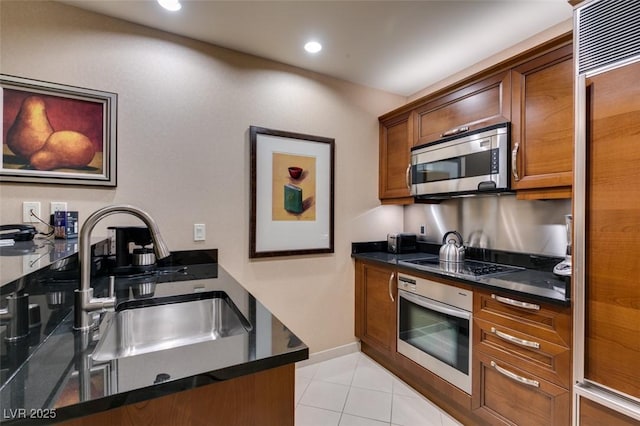 135 E Harmon Ave Unit 2821, Las Vegas, NV 89109 - kitchen with appliances with stainless steel finishes, dark countertops, light tile patterned floors, and recessed lighting