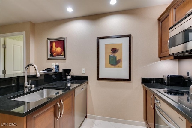 135 E Harmon Ave Unit 2821, Las Vegas, NV 89109 - kitchen featuring stainless steel microwave, brown cabinets, dishwashing machine, oven, and recessed lighting