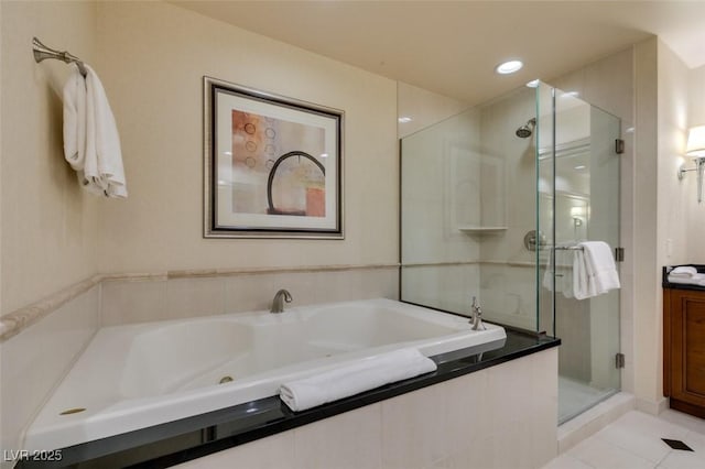 135 E Harmon Ave Unit 2821, Las Vegas, NV 89109 - bathroom featuring a shower stall, tile patterned floors, a whirlpool tub, and vanity