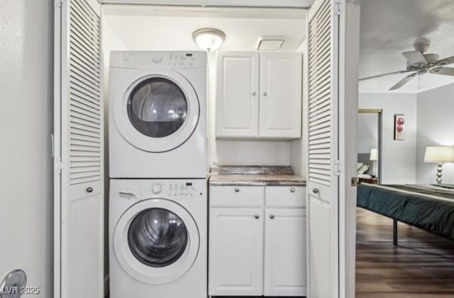 3145 E Flamingo Rd Unit 1045, Las Vegas, NV 89121 - laundry area with stacked washer and clothes dryer, ceiling fan, and cabinet space