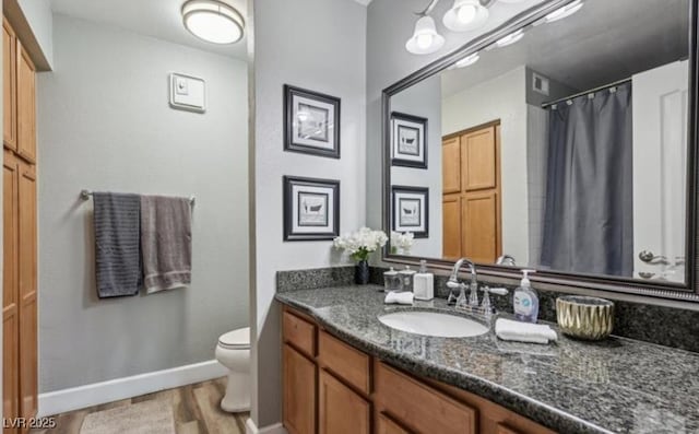3145 E Flamingo Rd Unit 1045, Las Vegas, NV 89121 - bathroom featuring vanity, wood finished floors, and a shower with shower curtain