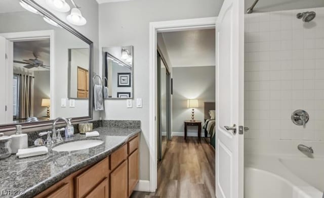 3145 E Flamingo Rd Unit 1045, Las Vegas, NV 89121 - bathroom with vanity,  shower combination, ceiling fan, and wood finished floors