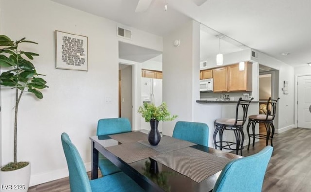 3145 E Flamingo Rd Unit 1045, Las Vegas, NV 89121 - dining room with wood finished floors and a ceiling fan