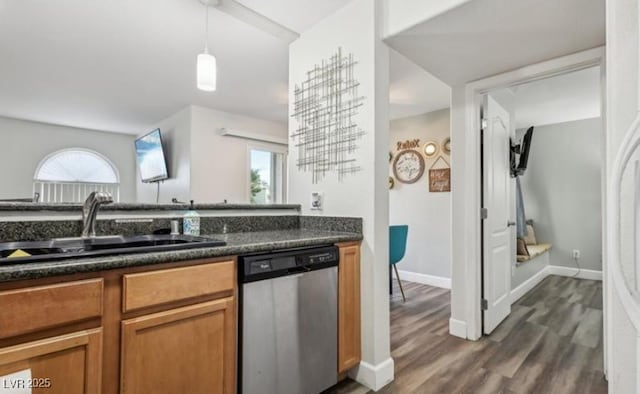 3145 E Flamingo Rd Unit 1045, Las Vegas, NV 89121 - kitchen featuring stainless steel dishwasher, dark countertops, brown cabinetry, dark wood finished floors, and pendant lighting