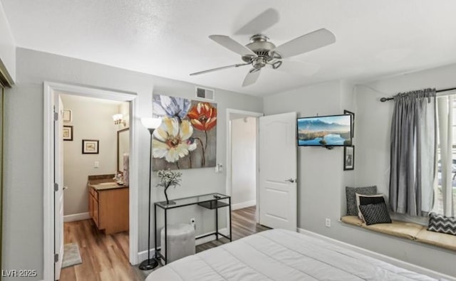 3145 E Flamingo Rd Unit 1045, Las Vegas, NV 89121 - bedroom featuring wood finished floors, ensuite bathroom, and ceiling fan