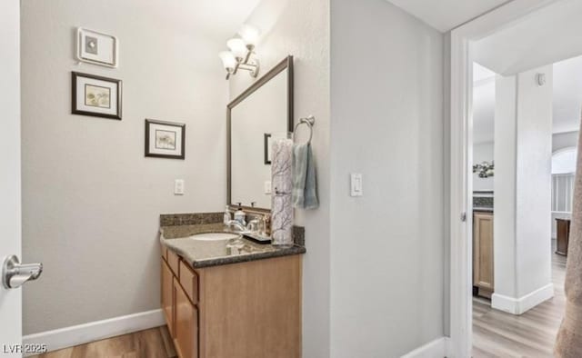 3145 E Flamingo Rd Unit 1045, Las Vegas, NV 89121 - bathroom featuring wood finished floors and vanity