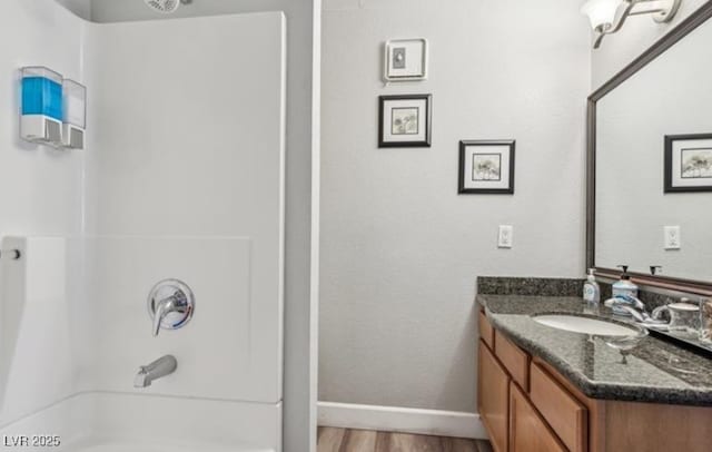3145 E Flamingo Rd Unit 1045, Las Vegas, NV 89121 - full bathroom with vanity, washtub / shower combination, and wood finished floors