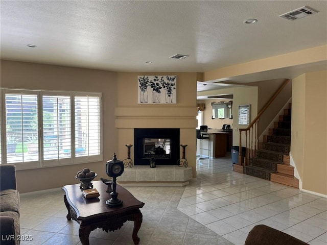 8225 Bermuda Beach Dr, Las Vegas, NV 89128 - living room with plenty of natural light, stairs, a fireplace, a textured ceiling, and recessed lighting