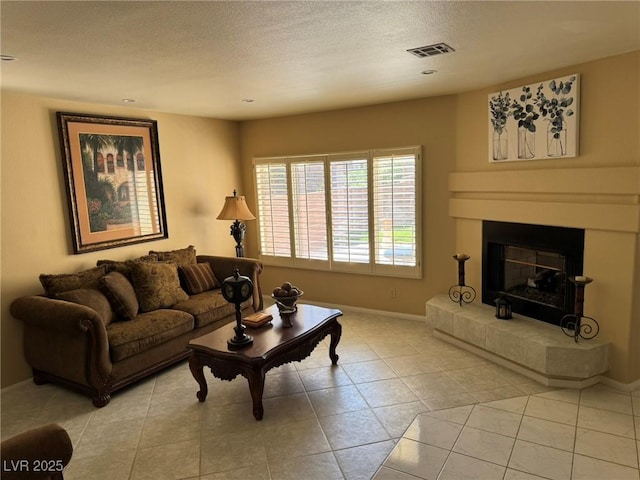 8225 Bermuda Beach Dr, Las Vegas, NV 89128 - living room with a textured ceiling, a glass covered fireplace, and light tile patterned floors