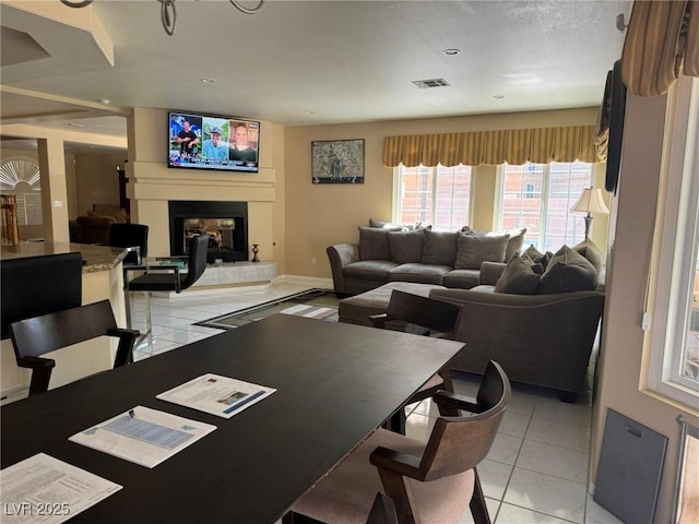 8225 Bermuda Beach Dr, Las Vegas, NV 89128 - dining space with a glass covered fireplace and light tile patterned flooring