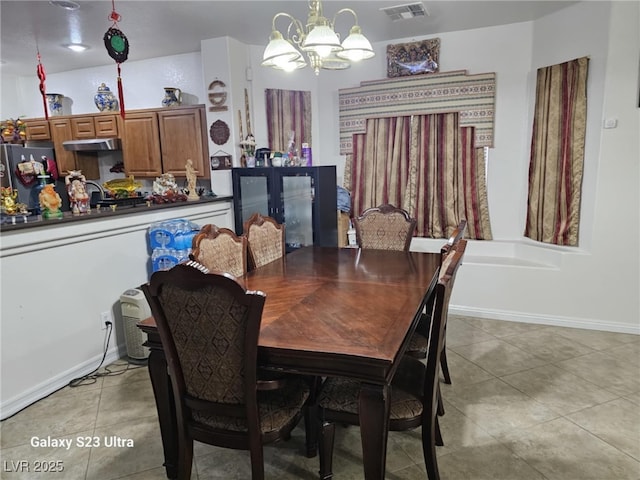 5651 Bettors Luck Ct, Las Vegas, NV 89122 - dining space featuring a chandelier and light tile patterned floors