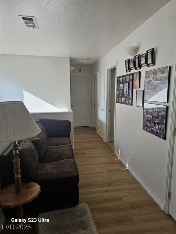 5651 Bettors Luck Ct, Las Vegas, NV 89122 - living room featuring wood finished floors and a textured ceiling