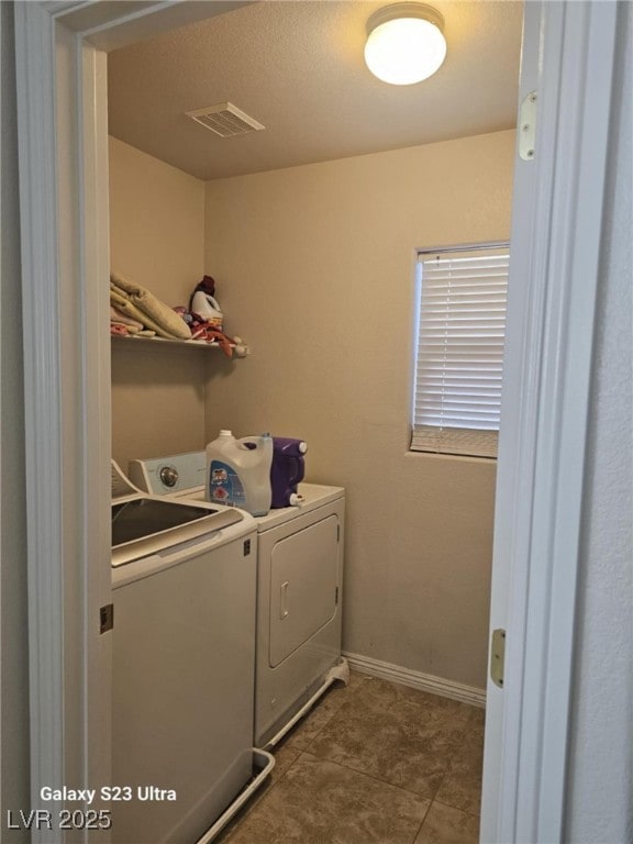 5651 Bettors Luck Ct, Las Vegas, NV 89122 - laundry room featuring washer and dryer and tile patterned floors