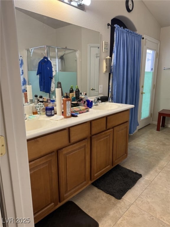 5651 Bettors Luck Ct, Las Vegas, NV 89122 - bathroom with a stall shower, double vanity, and tile patterned flooring