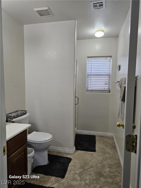5651 Bettors Luck Ct, Las Vegas, NV 89122 - bathroom with vanity, tile patterned flooring, and a shower stall