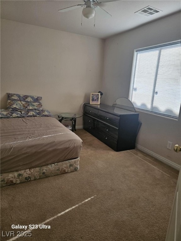 5651 Bettors Luck Ct, Las Vegas, NV 89122 - carpeted bedroom with a ceiling fan and baseboards